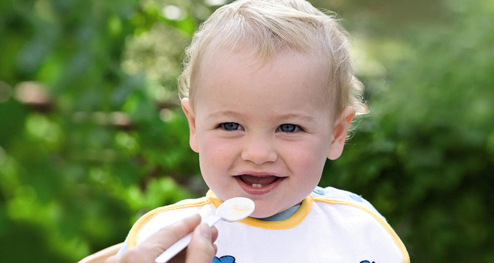 Un jeune enfant est nourri avec une cuillère.