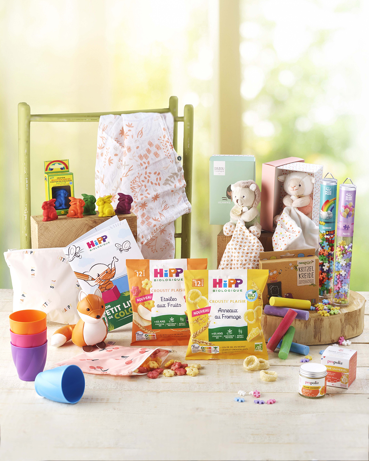 Une variété de produits et de jouets pour enfants sont présentés sur une table, y compris des collations, des jouets et du matériel éducatif.