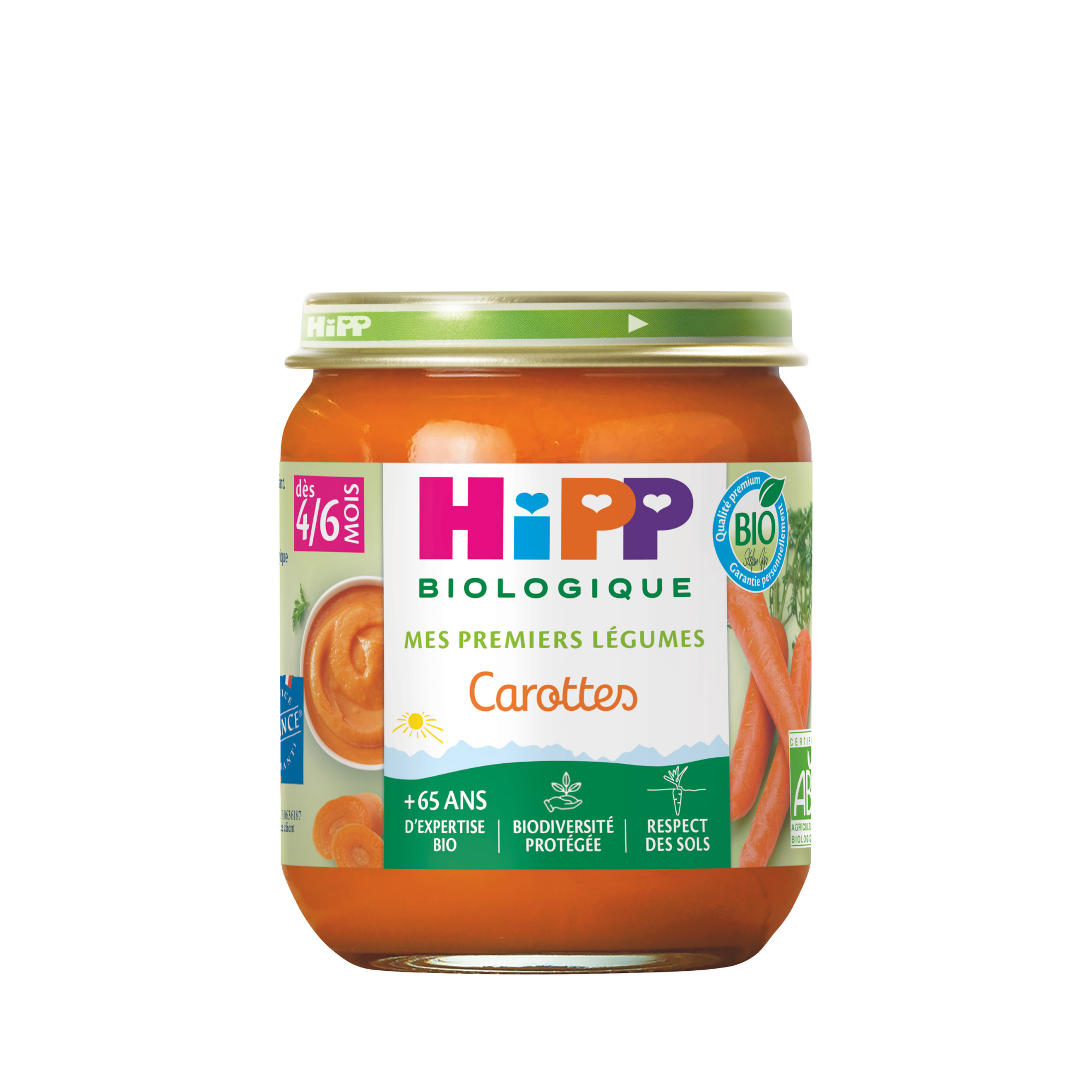 Un pot transparent à couvercle vert contient une purée orange vif, étiquetée "Hipp Biologique" et "Mes premières légumineuses Carottes", avec une certification bio et une recommandation d'âge de 4/6 mois.